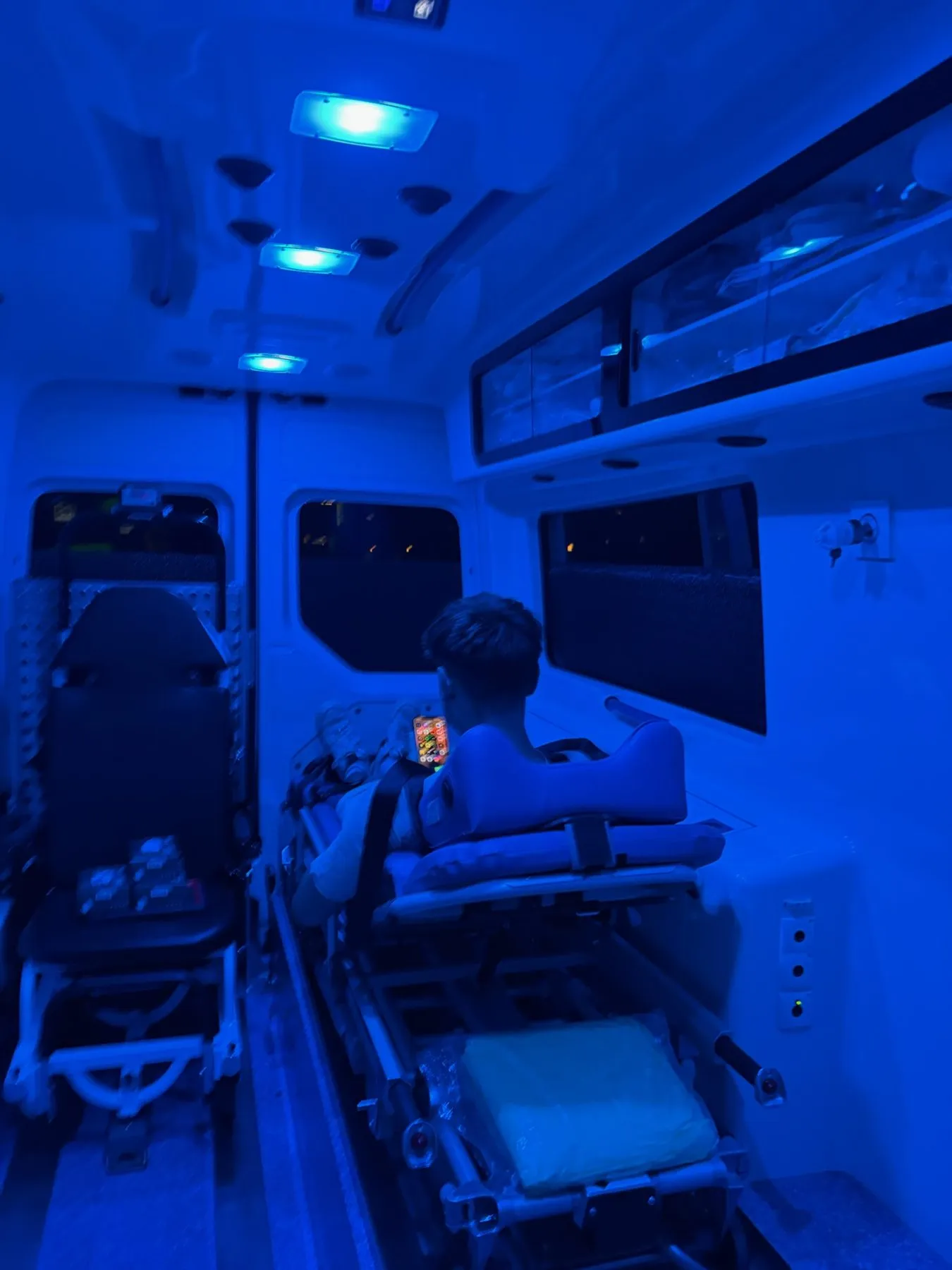 Blau beleuchteter Innenraum eines Krankentransportwagens mit Trage