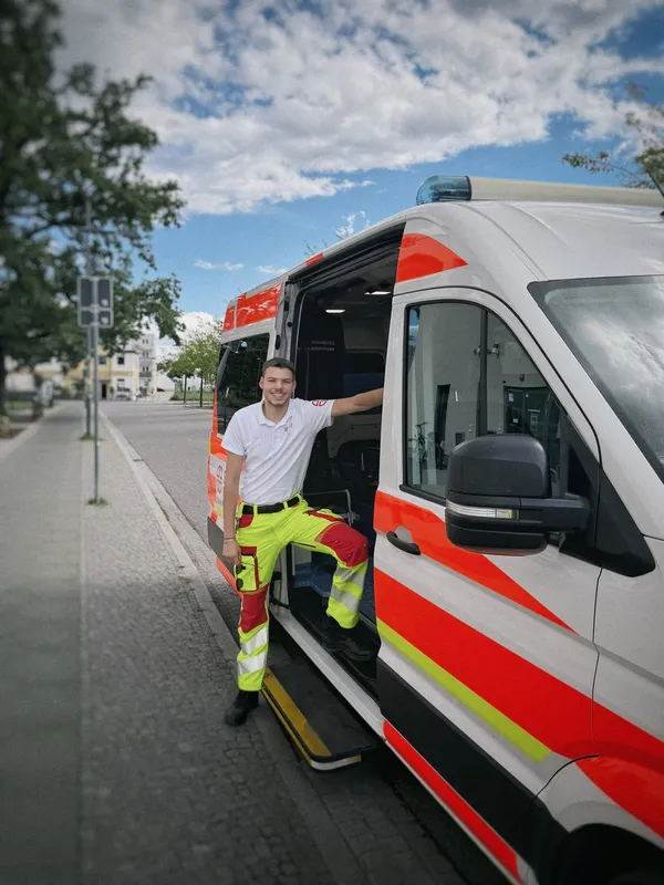 SKALA Paramedics medic standing in the open side door of the patient transport ambulance